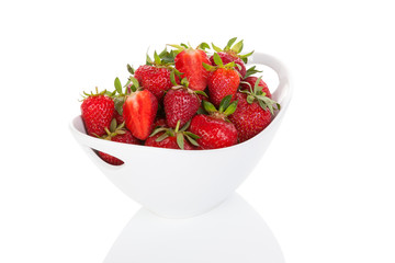 Strawberries in bowl isolated over white.