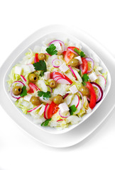 The Greek and Italian food - fresh vegetable salad on the table.