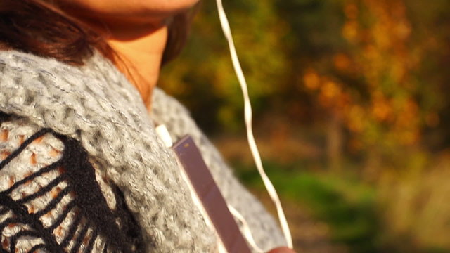 Woman wearing headphones and listening music, steadycam shot, slow motion shot at 240fps
