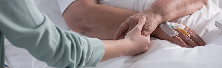 Female holding cancer patient hand