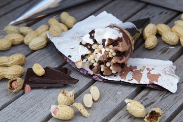 Vanilla cone with chocolate and peanuts