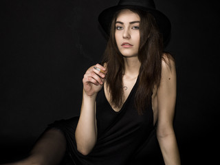 Pretty girl portrait with gorgeous eyes smoking cigarette