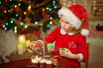Merry Christmas - Little pretty girl in hat holding plate with c