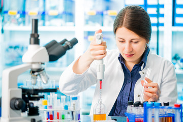 laboratory assistant analyzing a blood sample