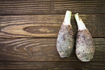 Fresh taro on wooden background.