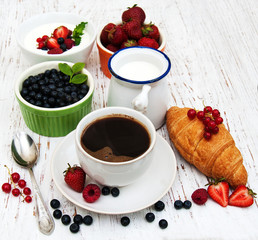 Fresh berries, coffee  and croissant