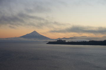 Sunrise over Snow capped Volcano Osorno (2,652 metres) on the edge of Llanquihue Lake in Southern Chile. Viewed from Puerto Varas.