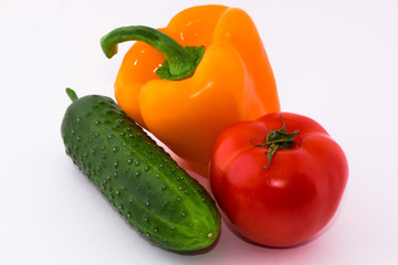 Перец, томат и огурец на белом фоне