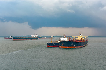 Loading anchored oil supertanker via a ship-to-ship oil transfer © Igor Groshev