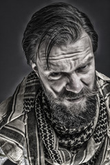 Fototapeta na wymiar Closeup portrait of a frustrated man with beard wearing a tradit