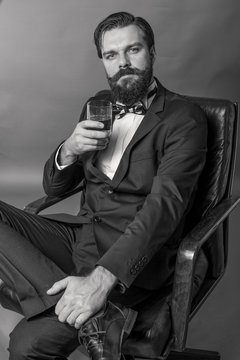 Portrait of an elegant young fashion man with retro look sitting