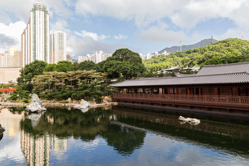 Pond and traditional wooden tea house at the Nan Lian Garden in Hong Kong, China.