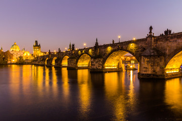 Fototapeta premium View at The Charles Bridge and Vltava river in Prague in dusk at sunset, Czech Republic