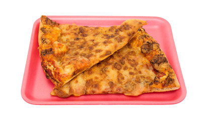 Day old pizza on pink foam tray