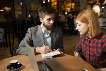 Business meeting of director and worker in cafe