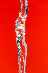 a jet of water on a red background