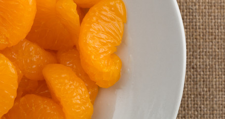 Canned mandarin oranges on a plate top close view