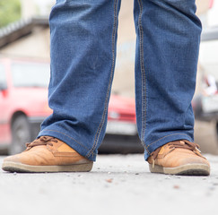 male legs in jeans and shoes