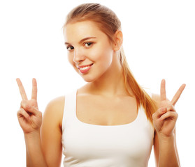 Obraz na płótnie Canvas portrait of happy young woman giving peace sign