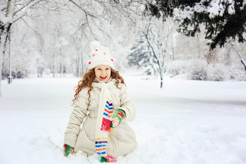 Fototapeta na wymiar Laughing girl in winter park. Happy holiday and childhood concep