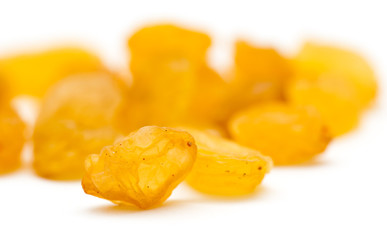 Golden raisins on a white background