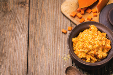 Full pot of porridge with pumpkin and millet. Space for text