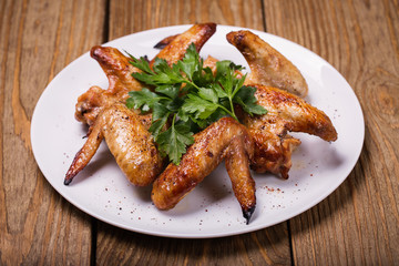 Baked chicken wings in the oven closeup