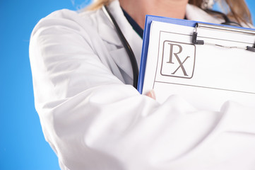 Female doctor holding a clip with medical prescription