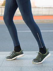 Close-up of Athlete shoes while running in park. Fitness concept