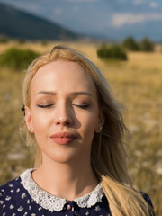 Close up side view portrait of a cute smiling young woman