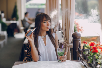 girn in cafe with E-Cigarette