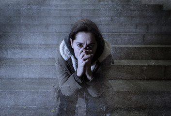sad woman alone on street subway staircase suffering depression