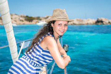 Gorgeous girl on a sailboat in a magnificent turquoise lagoon, Budelli Island, Sardinia, Italy