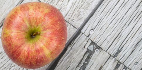 Fresh Japanese Fuji apple over wooden background