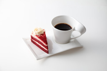 Cup of coffee with delicious red velvet cake isolated on white background