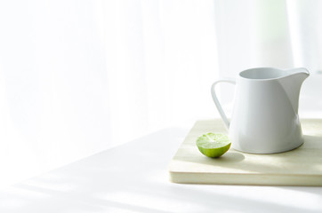 Still life with lemon and white jug
