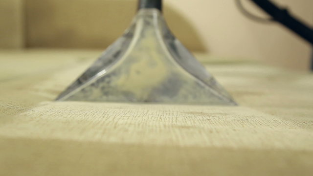 Service cleaning dirty sofa and chairs with special tool, the detergent is applied, operation of the wet and dry vacuum cleaner
