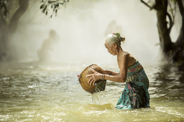 old woman looking for fish streams.