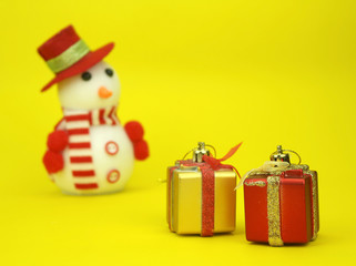 Blured toy snowman  is standing beside christmas decoration