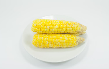 Corn cooked in a white container.
