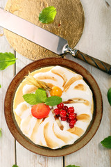 Pudding cake with fruit on a wooden background