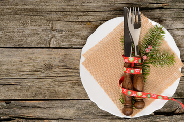 Christmas table place setting with christmas pine branches and ribbon. Christmas holidays background