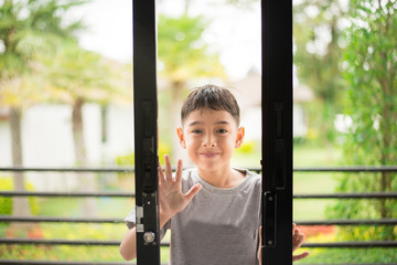 Little boy opening door in the house