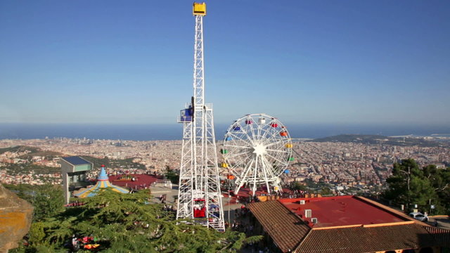 BARCELONA, SPAIN - AUGUST 29, 2015:  Amusement Park  at Tibidabo  in Barcelona, Spain.  Park is oldest amusement park in Spain.Сhurch dedicated to Sacred Heart, lasted from 1902 to 1961