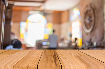 Selected focus empty brown wooden table and Coffee shop blur bac
