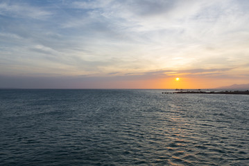 Colorful ocean beach sunset with deep blue sky and sun rays on the harbor of Margarita, Venezuela.