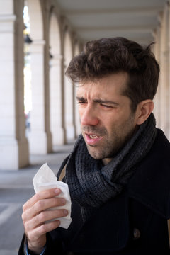 Man sneeze and handkerchief