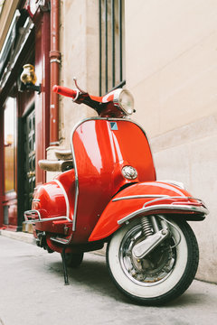 Red retro scooter on the european street