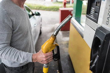 Man holding a fuel pump nozzle