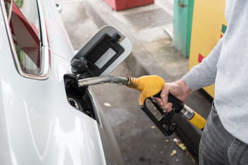 Man holding a fuel pump nozzle